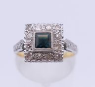 An Art Deco style 18 ct gold diamond and sapphire ring. Ring size M. 4.6 grammes total weight.