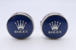A pair of cufflinks stamped Rolex. 1.5 cm diameter.