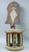 A tribal carved wooden folding chair. 94 cm high.