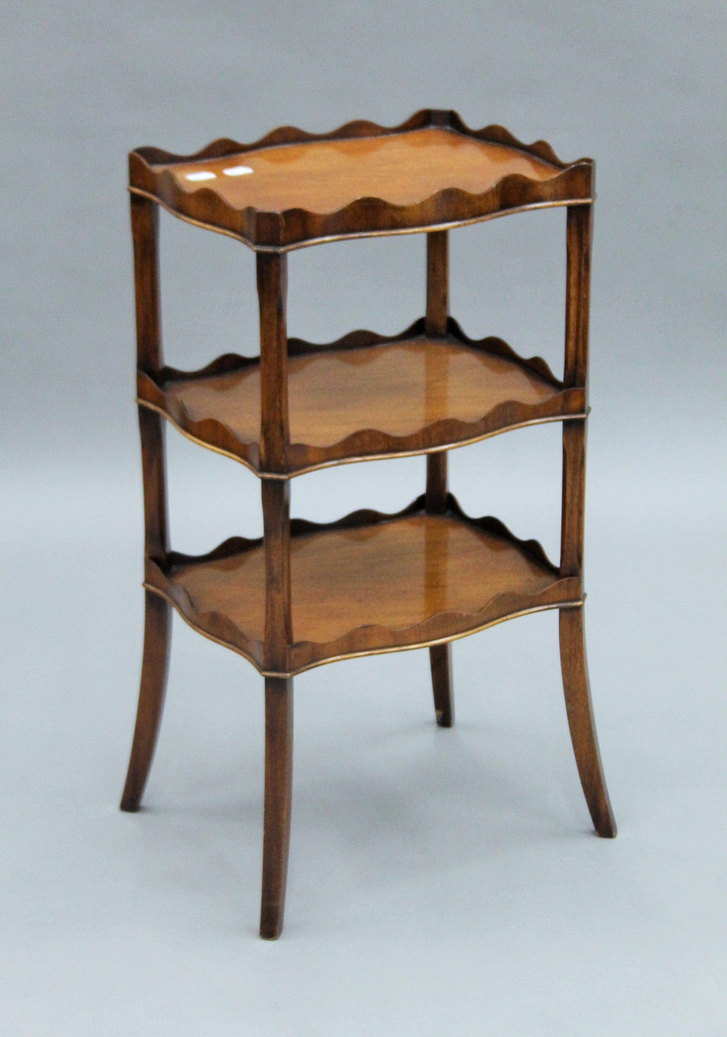 A three-tier mahogany Reprodux side table. 67.5 cm high. - Image 2 of 4