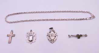 Two silver fobs, a silver necklace, a silver cross and a silver shamrock bar brooch.