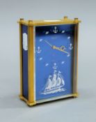 A Jaeger brushed brass mantel clock with perspex face decorated with sailing ship. 12.5 cm high.