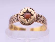 A Victorian 18 ct gold coral set ring. Ring size H/I. 2 grammes total weight.