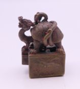 A small bronze double seal formed as tortoise and dragon. 3 cm high.