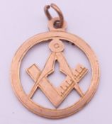 A 9 ct gold Masonic pendant. 2 cm diameter. 1.6 grammes.