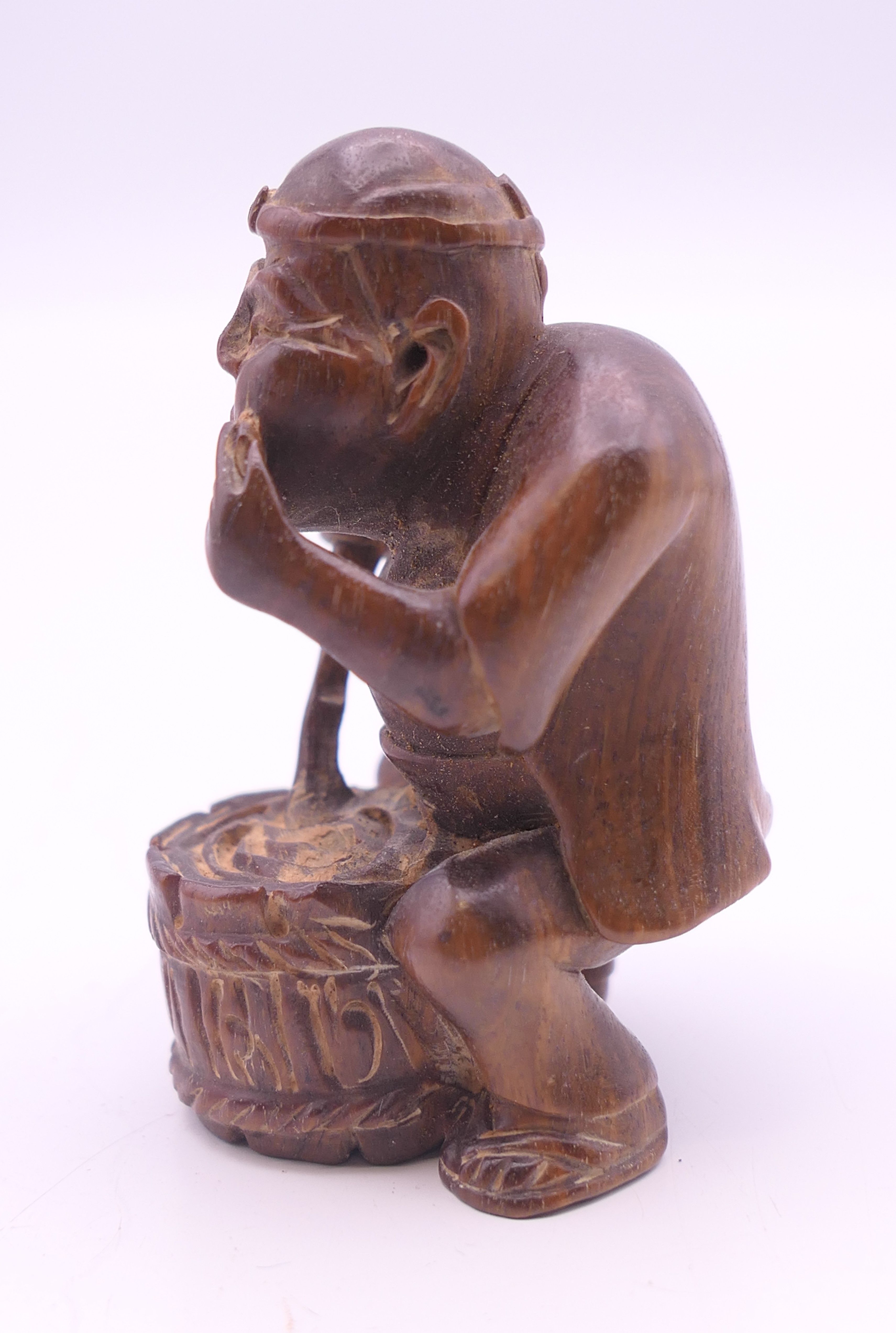 A netsuke formed as a man with a barrel. 6 cm high. - Image 3 of 4