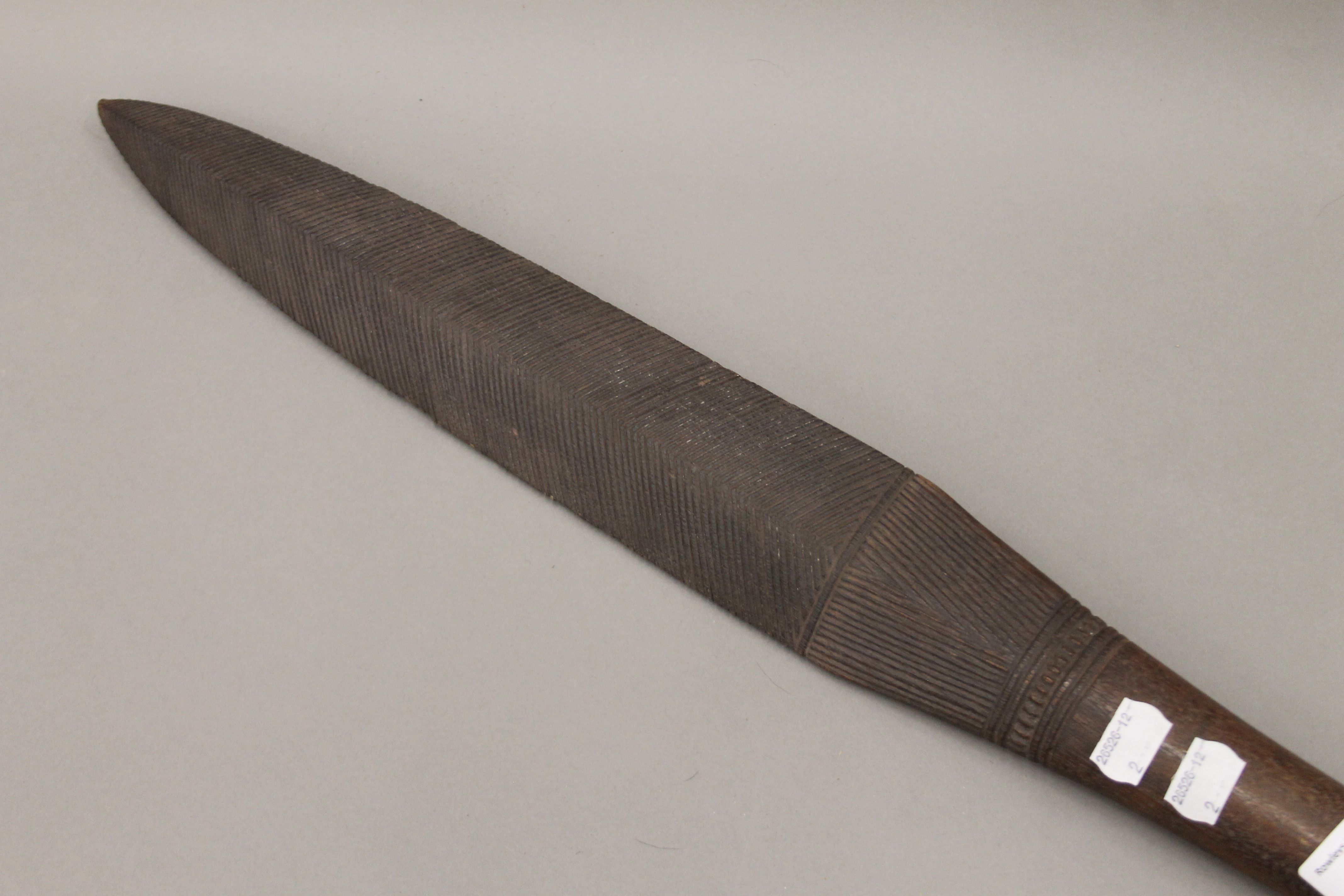 A South Seas carved wooden club. 103.5 cm long. - Image 2 of 3