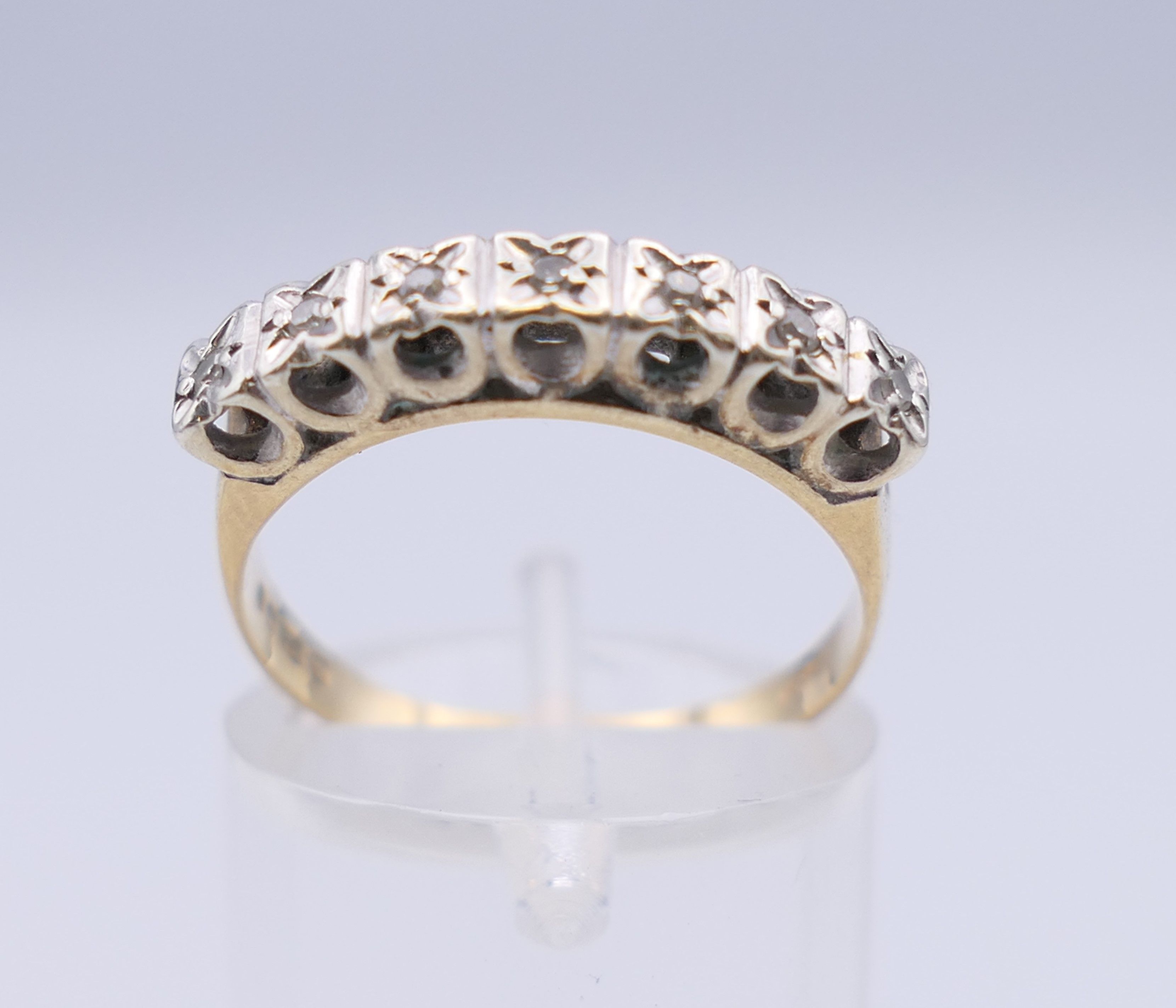 A 9 ct gold seven stone diamond ring. Ring size N/O. 2.5 grammes total weight. - Image 4 of 8