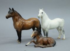 A Beswick Grey Welsh mountain pony and two brown ponies. The former 15 cms high.
