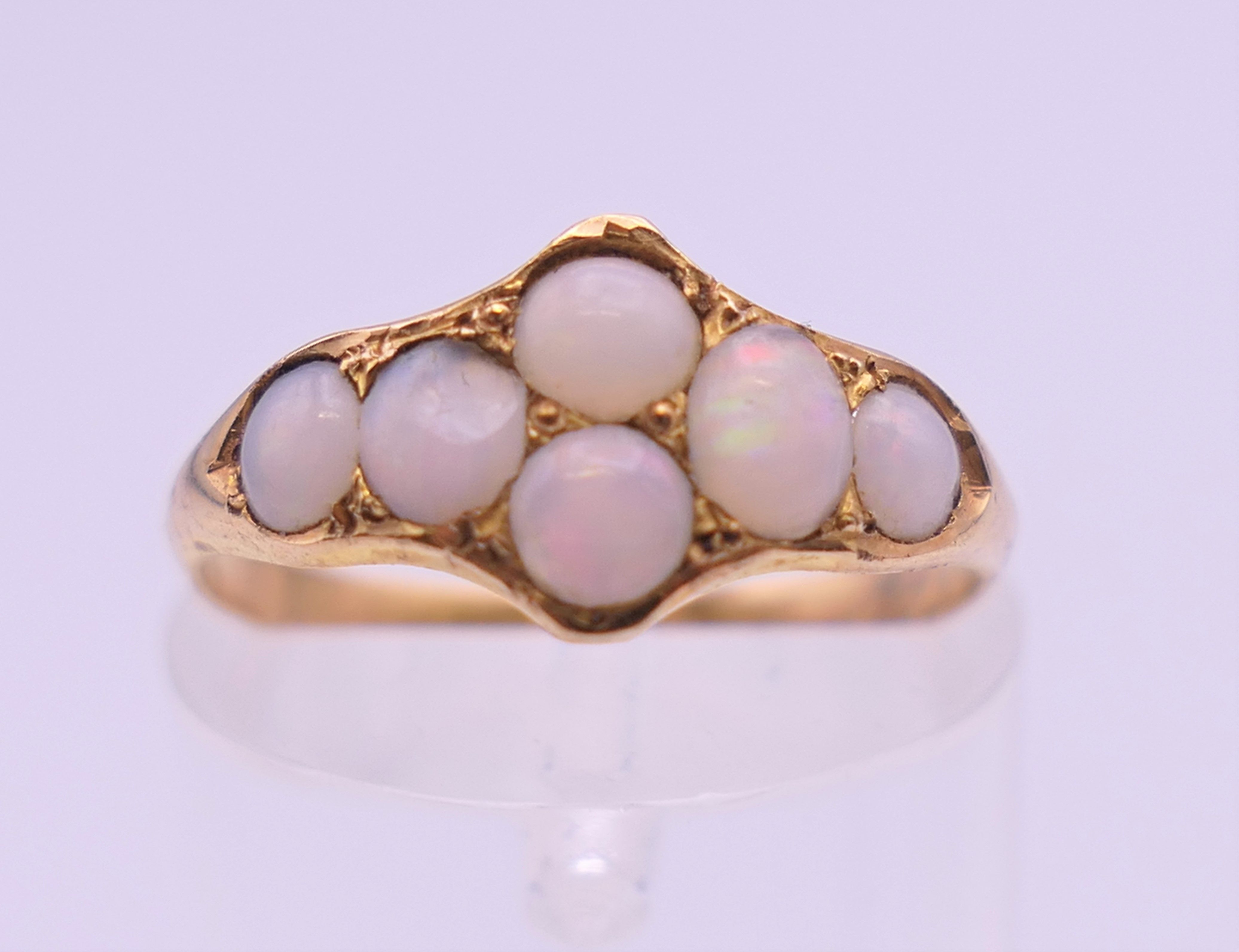 An unmarked gold opal set ring. Ring size K/L. 1.5 grammes total weight.