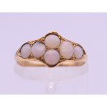 An unmarked gold opal set ring. Ring size K/L. 1.5 grammes total weight.