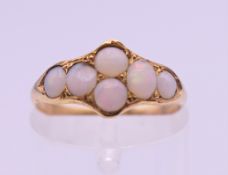 An unmarked gold opal set ring. Ring size K/L. 1.5 grammes total weight.