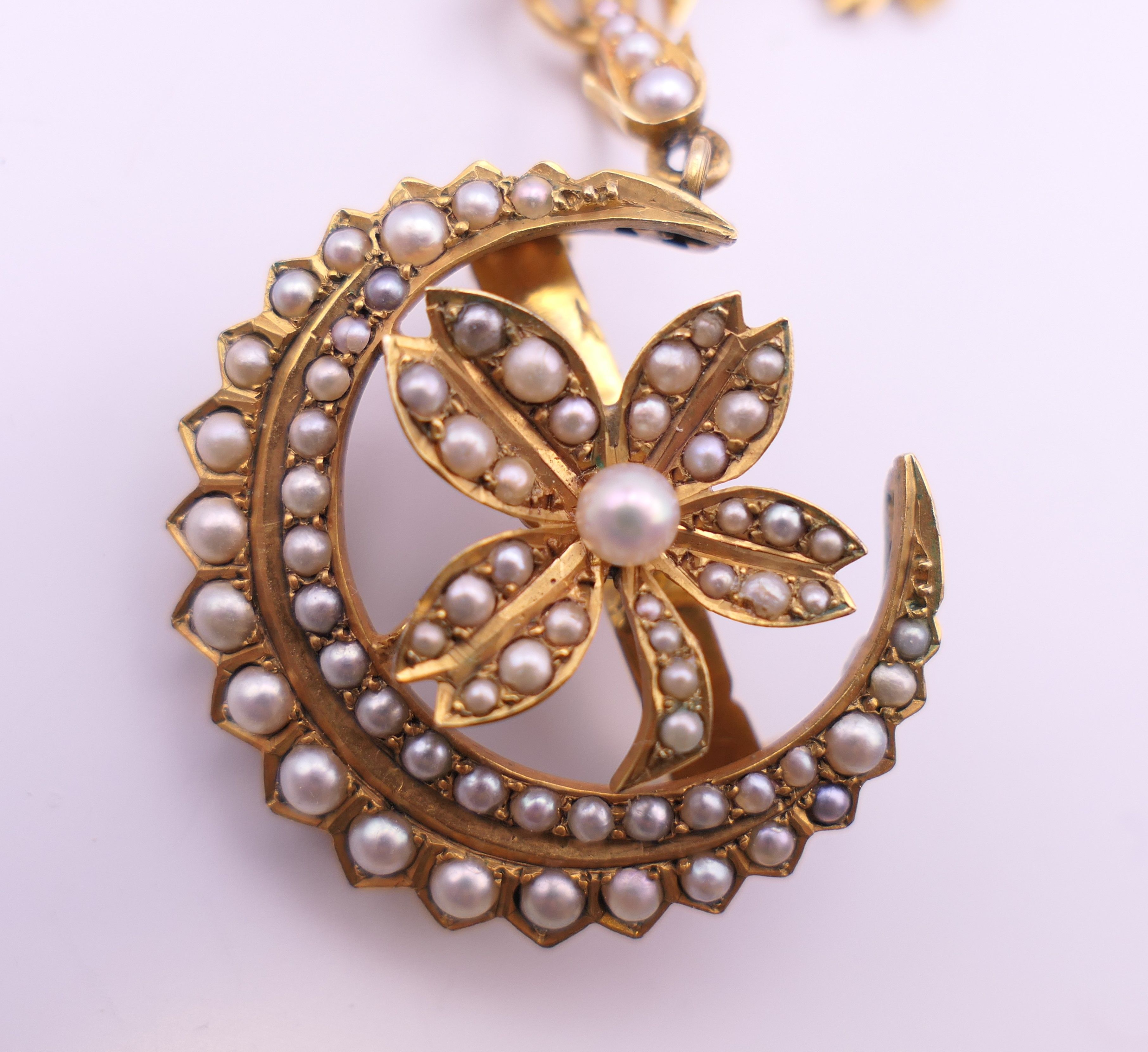An unmarked gold seed pearl set necklace of scrolling floral form and detachable pendant formed as - Image 11 of 16