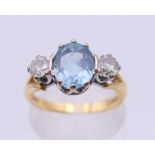 An 18 ct gold diamond and aquamarine ring. Ring size L/M.