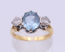 An 18 ct gold diamond and aquamarine ring. Ring size L/M.