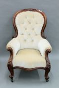 A Victorian mahogany button upholstered spoon back armchair. 73 cm wide.