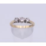 A 9 ct gold three stone diamond ring. Ring size O. 2.1 grammes total weight.