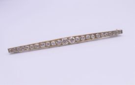 An unmarked white gold diamond bar brooch. Approximate diamond weight 2 carats. 8 cm long. 6.