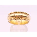 A Theo Fennell 18 ct gold band/ring, boxed and with paperwork of authenticity. Ring size R/S. 18.
