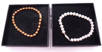 Two pearl bracelets.