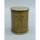 A WWI shell canister, the lid chased with Arabic writing and body chased with birds, figure, etc.