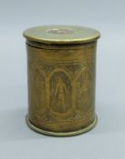 A WWI shell canister, the lid chased with Arabic writing and body chased with birds, figure, etc.