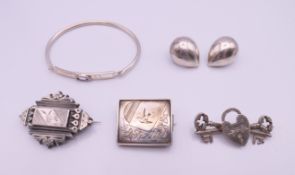 A quantity of silver jewellery including brooches, a bangle and a pair of earrings.