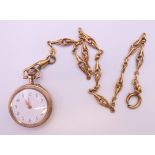 A gold plated pendant watch on chain. Watch 3 cm diameter, chain 31 cm long.