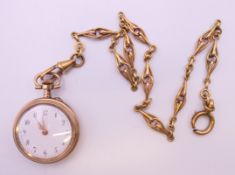A gold plated pendant watch on chain. Watch 3 cm diameter, chain 31 cm long.