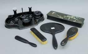 A ladies dressing table set, the brushes, mirror and shoehorn marked 'Real Ebony'.