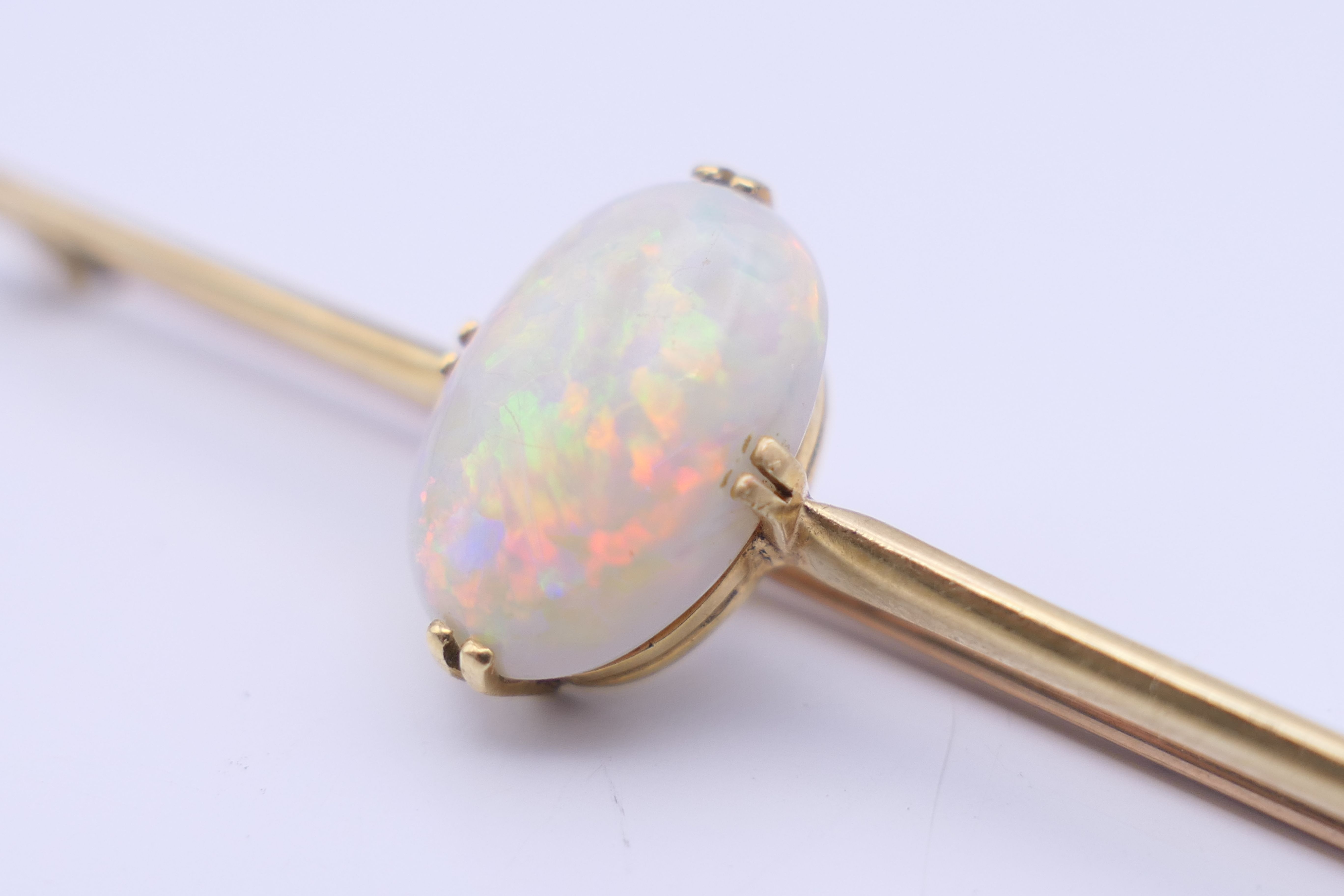 A 15 ct gold opal set bar brooch. 7 cm long, opal 1.5 cm high. 5.3 grammes total weight. - Image 3 of 9