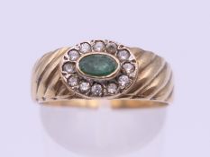 A 9 ct gold emerald dress ring. Ring size Q/R. 3.6 grammes total weight.
