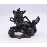 An 18th century Chinese bronze scroll weight in the form of a temple dog. 6 cm high.