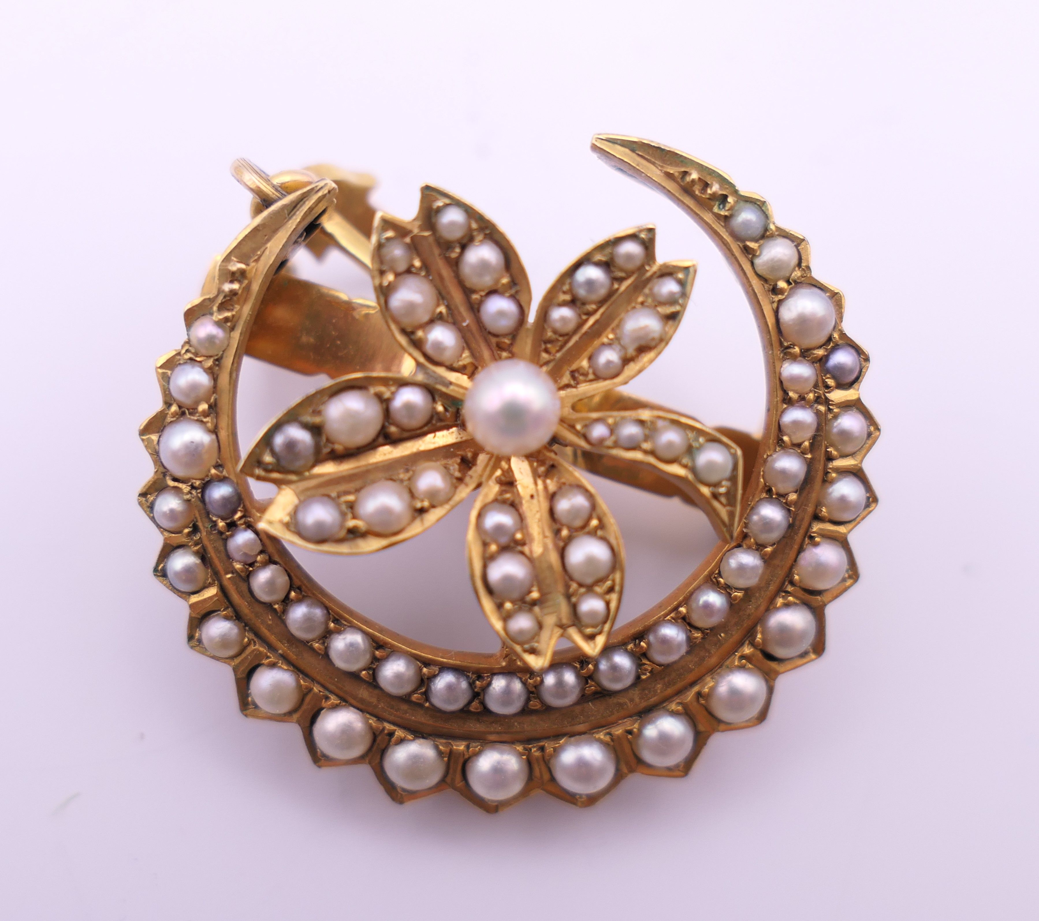 An unmarked gold seed pearl set necklace of scrolling floral form and detachable pendant formed as - Image 12 of 16