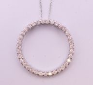 A 9 ct white gold halo shaped diamond set pendant necklace. Approximate diamond weight 0.75 carat.