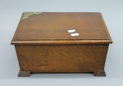 A brass mounted oak sewing box. 32 cm wide.