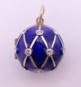 A silver enamel ball locket. 2 cm high.