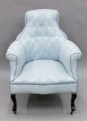 A Victorian blue upholstered armchair. 69 cm wide.