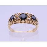 An 18 ct gold diamond and sapphire ring. Ring size L/M. 5 grammes total weight.