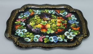 A large toleware tray decorated with birds, fruit and flowers. 75.5 cm long.