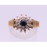 An 18 ct gold diamond and sapphire cluster ring. Ring size O/P. 4.8 grammes total weight.