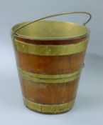 A brass bound bucket. 32 cm high.