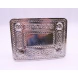 A belt buckle with Celtic knot motif. 9.25 x 7 cm.