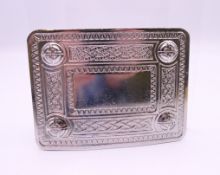 A belt buckle with Celtic knot motif. 9.25 x 7 cm.