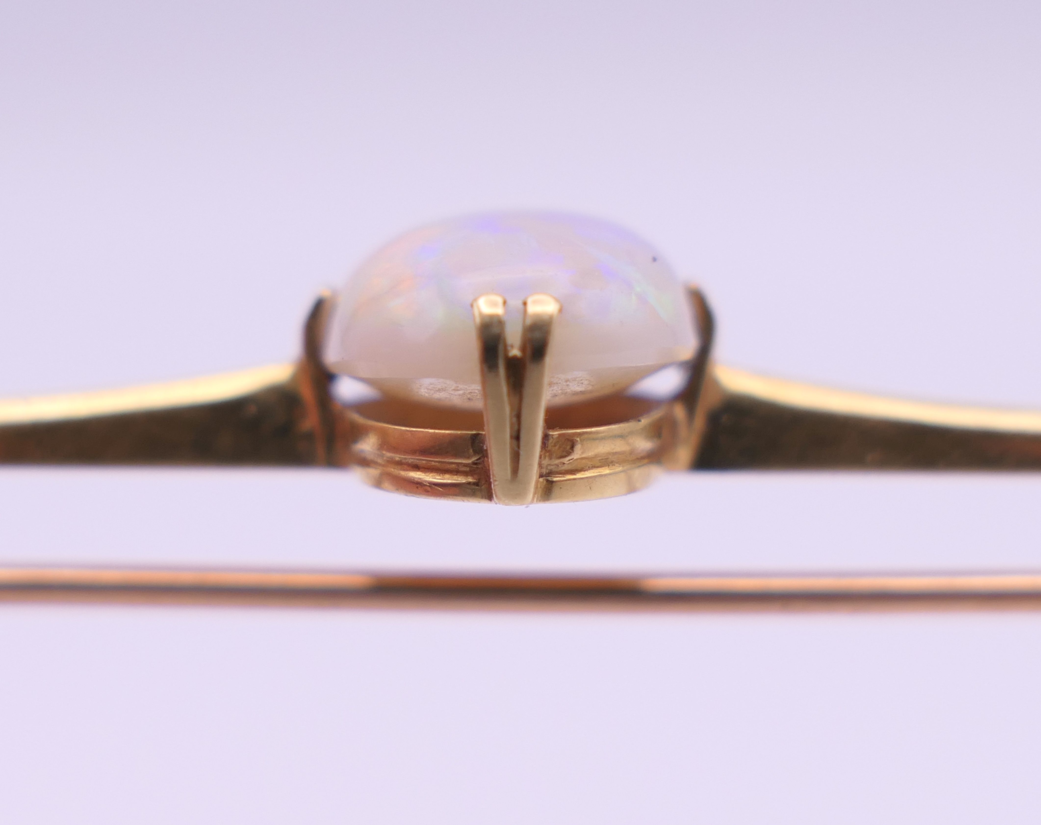 A 15 ct gold opal set bar brooch. 7 cm long, opal 1.5 cm high. 5.3 grammes total weight. - Image 5 of 9