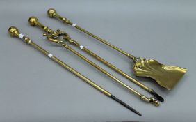 A set of three Victorian brass fireirons. The shovel 70 cms long.