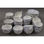 A quantity of Blue Denmark pattern porcelain tea cups and saucers.