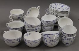 A quantity of Blue Denmark pattern porcelain tea cups and saucers.
