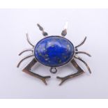 A silver lapis crab form brooch. 3 cm wide.