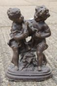 A garden ornament formed as two children. 42 cm high.